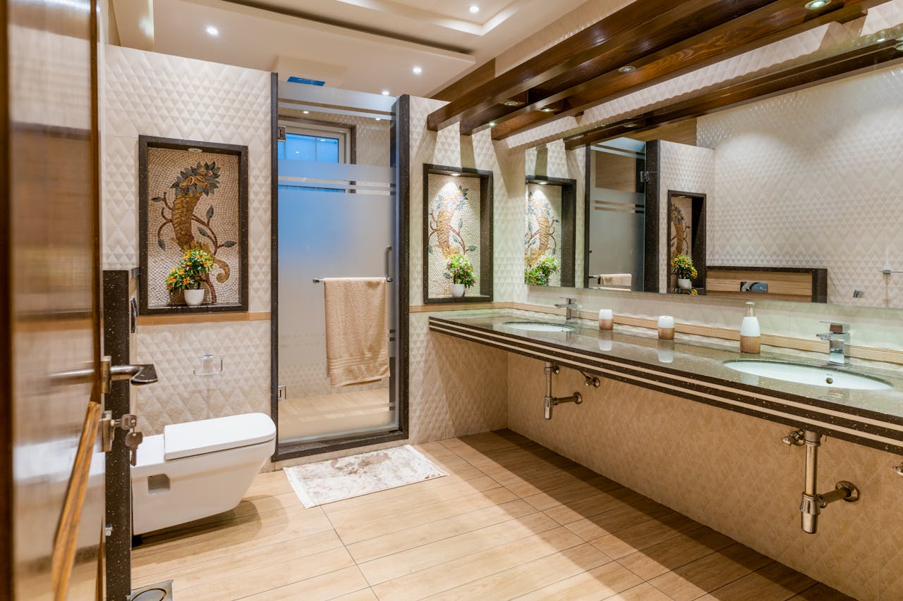 Luxurious modern bathroom featuring double sinks, stylish mirror, and elegant decor.